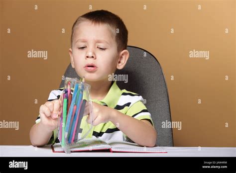 Little Boy Child Kid Drawing With Color Pencils On Brown Background