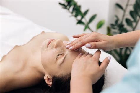 Young Caucasian Woman Getting Spa Massage Treatment At Beauty Spa Salon Face Massage Essential