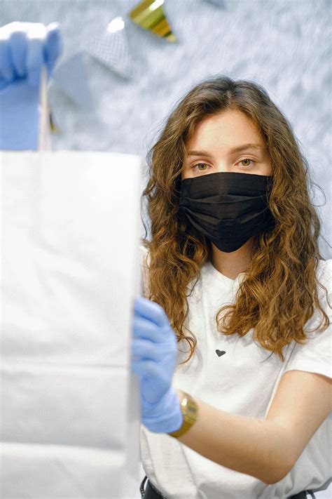 Woman With Face Mask And Latex Gloves Holding A Shopping Bag · Free