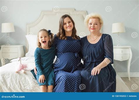A Grandmother And An Adult Granddaughter Communicate Standing On The