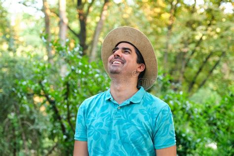 Smiling Man With A Straw Hat And A Blue Pole Shirt In Nature Stock