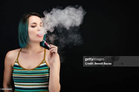 Young Woman Vape An Electronic Cigarette High Res Stock Photo Getty