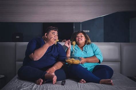 Premium Photo Fat Asian Couple Gaping At The Instant Noodle