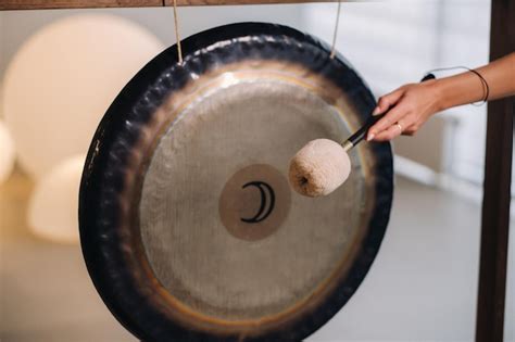 Premium Photo Closeup Of A Womans Hand Pounding A Gong With A Hammer