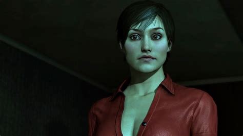 A Woman In A Red Leather Shirt Looking At The Camera With An Evil Look