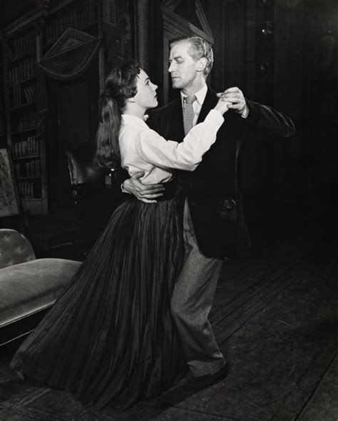 A Man And Woman Dance Together In An Old Photo