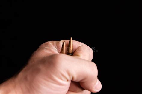 Bullets In A Hand Hand Holding A Bullet On Black Background Stock