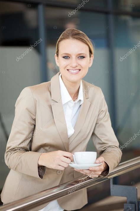 Beautiful Female White Collar Worker Having Coffee Break At Work