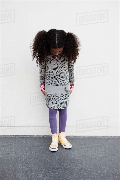Young Girl Looking Down Her Legs Stock Photo Dissolve