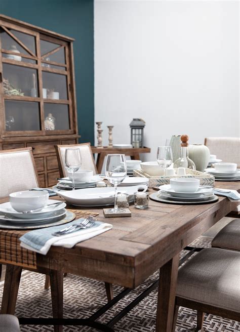 A table set for an outdoor dinner party. A modern beach house dining room featuring the Craftsman ...