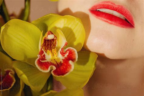 Crop Shot Of Red Lips And Orchid By Stocksy Contributor Liliya Rodnikova Stocksy