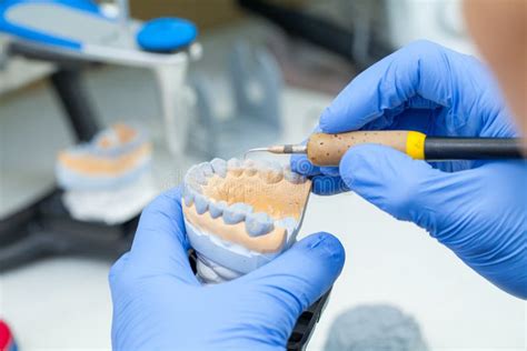 A Dental Technician Dentist Working With Prostheses In A Laboratory