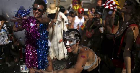 rio carnival revellers defy zika threat by hitting streets in colourful array of glitter