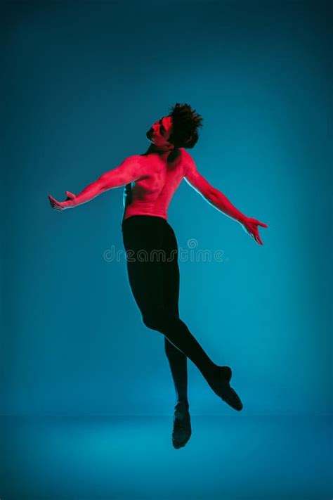 The Male Athletic Ballet Dancer Performing Dance On Blue Background