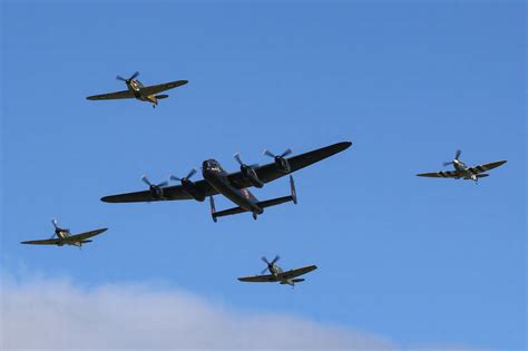 People Watch On In Awe As Historic Lancaster Spitfires And Hurricane