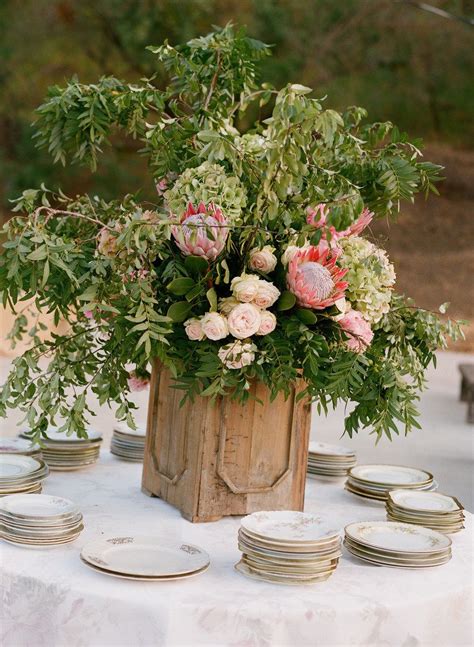 A rustic centerpiece with thistles, cottons, berries for a winter celebration. Ojai Valley Rehearsal Dinner from Elizabeth Messina ...