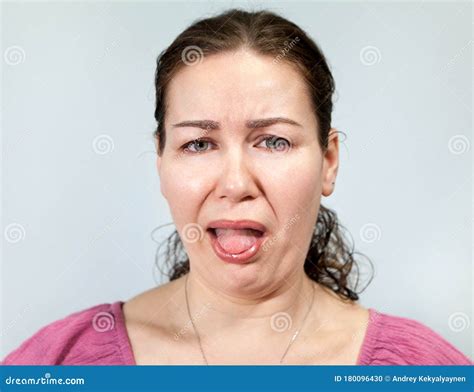 Disgust On A Woman`s Face Open Mouth And Sticking Tongue Portrait On