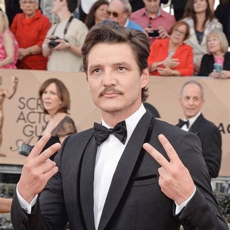 A Man In A Tuxedo Making The Peace Sign