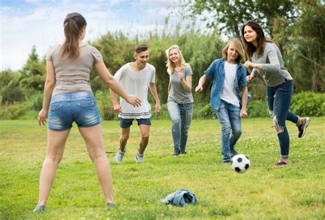 Teenagers Playing Football In Park Stock Photo Image Of Outdoors Energetic