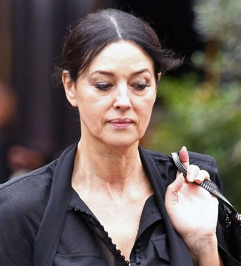 Her eye color is black and hair color is black. MONICA BELLUCCI Out for Lunch in Paris 07/16/2020 - HawtCelebs