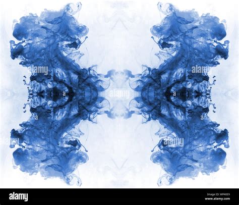Blue Ink Forming Patterns Resembling Rorschach Test Ink Blots Stock