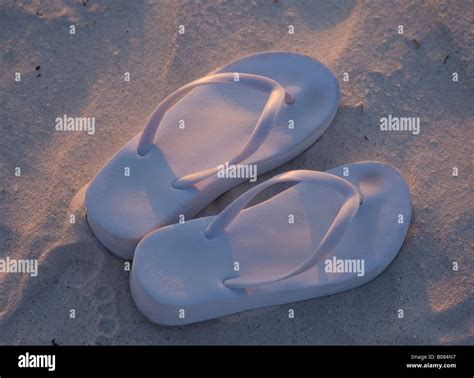 Pair Of Thongs On The Beach Stock Photo Alamy