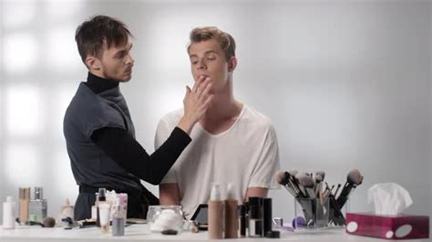 Male Makeup Artist Doing Make Up For Young Man Stock Footage Videohive