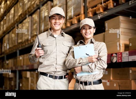 Male and female Chinese warehouse workers in full uniform Stock Photo