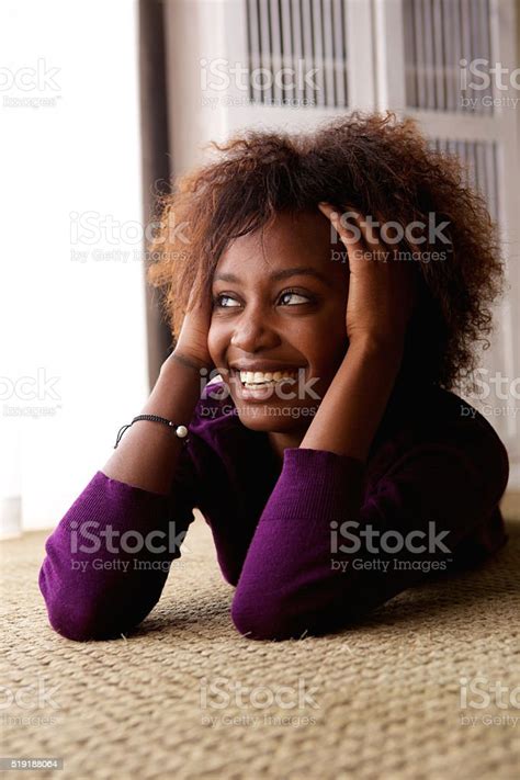 Black Woman Lying Down On Floor Smiling Stock Photo Download Image