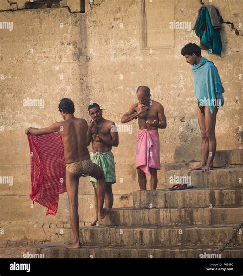 Men Doing Their Morning Ritual By The Ganges In Varanasi India Stock