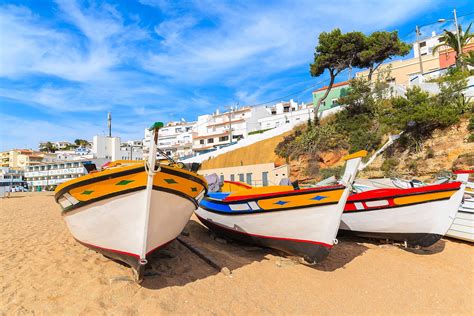 Traditional Colourful Fishing Boats On Beach In Carvoeiro Village