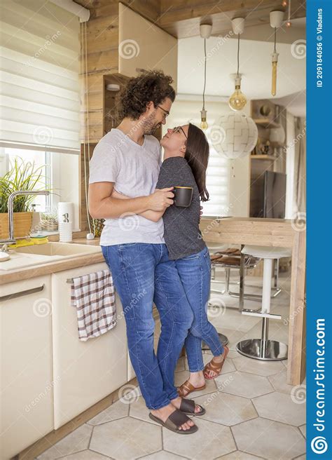 Couple Hugging Relaxing And Drinking Morning Coffee At Home Stock