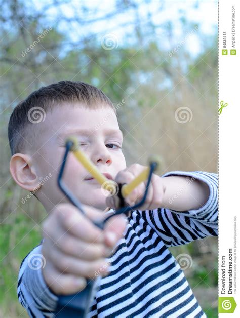 Young Boy Aiming Sling Shot At Camera Stock Image Image