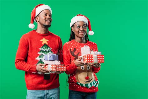 African American Couple In Red Christmas Sweaters And Santa Hats