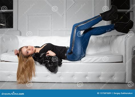 Alluring Woman Posing Lying On A Sofa Stock Image Image Of Jeans Lies