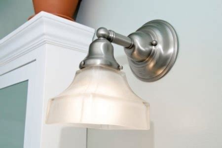 If you cannot remove fixture with your hands, use the flathead screwdriver or razor knife to pry it off by sliding it under the mouth of the metal collar and prying down. How to Replace Your Bathroom Vanity Light Fixture ...
