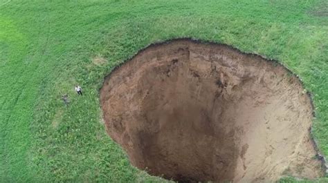 Watch Massive Sinkhole Mysteriously Emerges Overnight In Russian Village