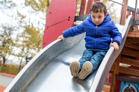 Little Boy Sliding Down A Slide Stock Photo Pixeltote