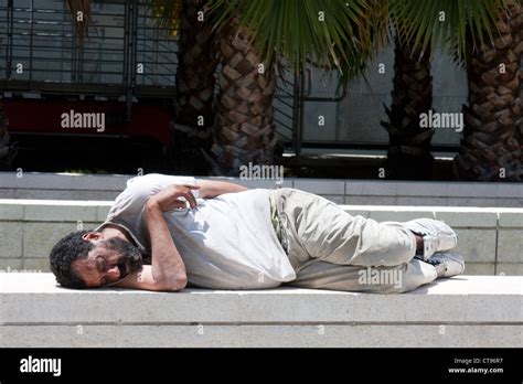 Homeless Man Sleeping On Sidewalk High Resolution Stock Photography And