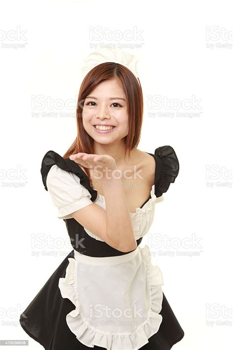 Young Japanese Woman Wearing French Maid Costume Blowing A Kiss Stock