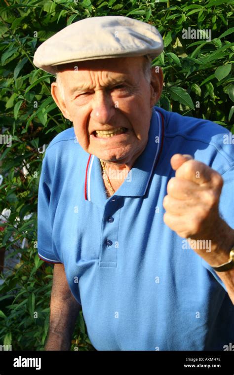 Angry Grumpy Old Man Shaking His Fist At The World Stock Photo Alamy