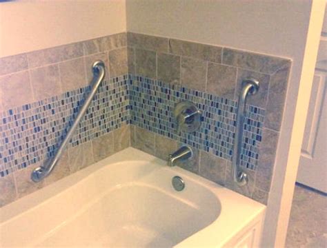On the control end wall, the handrail should be a minimum 24 inches in length at the front end of the bathtub (the side with the faucets). Grab bars, hand rails, transfer aids - Schaffer Construction