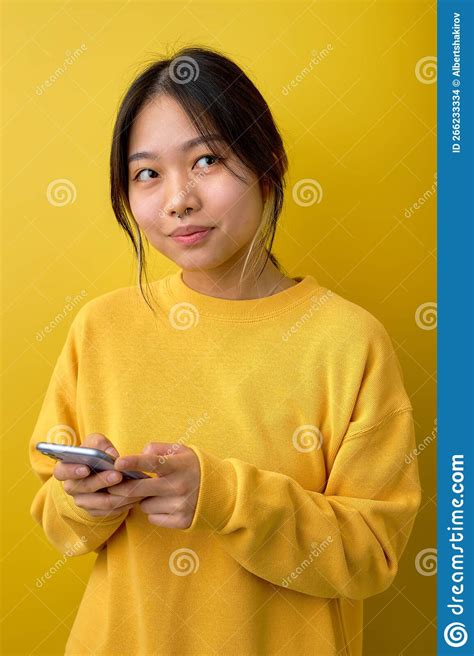 Photo Of Adorable Asian Lady Holding Telephone In Hands Reading New Positive Comments Stock
