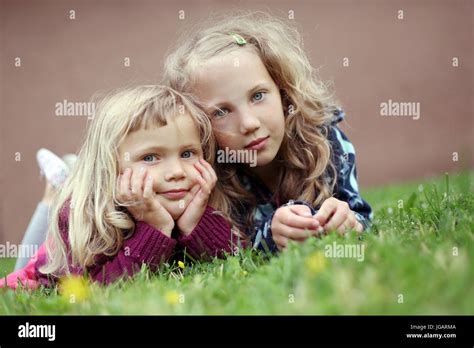 Children Sisters Two Girls Lies In Grass Smile Stock Photo Alamy