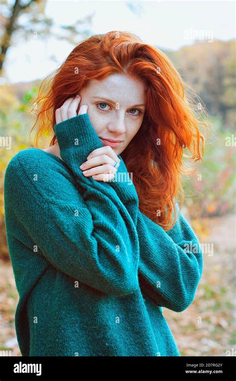 Portrait Of A Beautiful Red Haired Girl With Freckles And Blue Eyes In