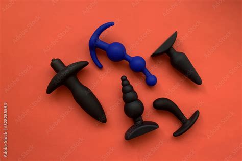 Black Sex Toys Five Butt Plugs On Red Background Useful For Sex Shop