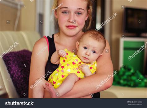 Photo De Stock Tween Year Old Girl Holding Her 200916806 Shutterstock
