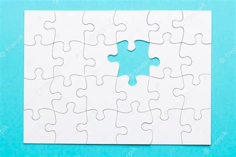 White Jigsaw Puzzle With One Missing Piece On Blue Backdrop Free Photo