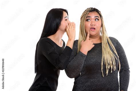 Young Asian Transgender Woman Whispering To Fat Asian Woman Look Stock