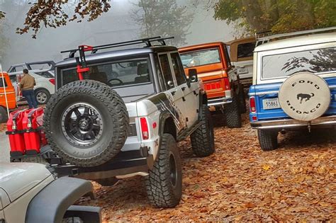 Several Jeeps Are Parked In The Woods